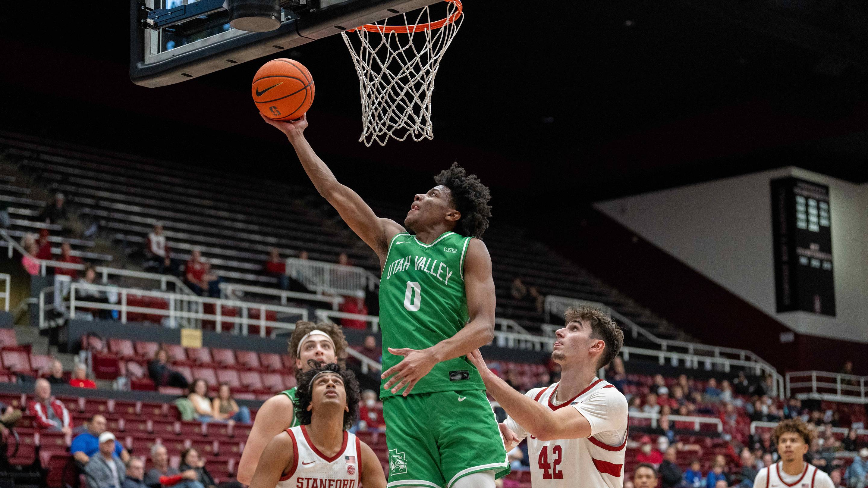 Dec 3, 2024; Stanford, California, USA; Utah Valley Wolverines guard Dominick Nelson (0) shoots a layup against Stanford Cardinal forward Maxime Raynaud (42) during the second half at Maples Pavilion. Mandatory Credit: Neville E. Guard-Imagn Images | USA TODAY Sports via Reuters Connect
