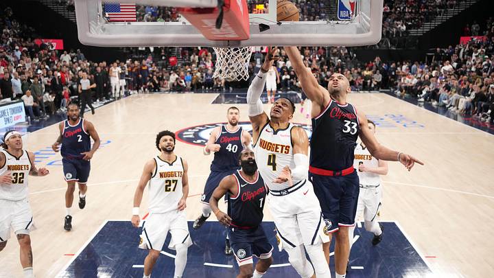 May 1, 2025; Inglewood, California, USA; LA Clippers forward Nicolas Batum (33) blocks a shot by Denver Nuggets guard Russell Westbrook (4) in the second half  during game six of first round for the 2025 NBA Playoffs at Intuit Dome. Mandatory Credit: Kirby Lee-Imagn Images