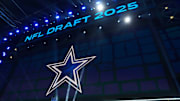 The Dallas Cowboys logo is projected on the video board during the NFL Draft at Lambeau Field.
