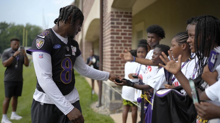 Jul 27, 2023; Owings Mills, MD, USA; Baltimore Ravens quarterback Lamar Jackson (8) greets fans after training camp practice at Under Armour Performance Center. Mandatory Credit: Brent Skeen-USA TODAY Sports