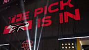 The Atlanta Falcons logo is projected on the video board during the NFL Draft at Lambeau Field. 