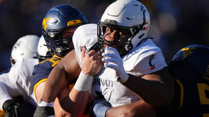 Cincinnati Bearcats defensive lineman Dontay Corleone (2) is double-teamed on a pass rush in the first quarter during an NCAA college football game between the Cincinnati Bearcats and the West Virginia Mountaineers, Saturday, Nov. 18, 2023, at Milan Puskar Stadium in Morgantown, W. Va.