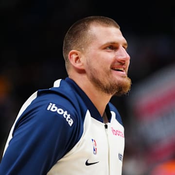Nov 25, 2024; Denver, Colorado, USA; Denver Nuggets center Nikola Jokic (15) reacts before the game against the New York Knicks at Ball Arena. Mandatory Credit: Ron Chenoy-Imagn Images