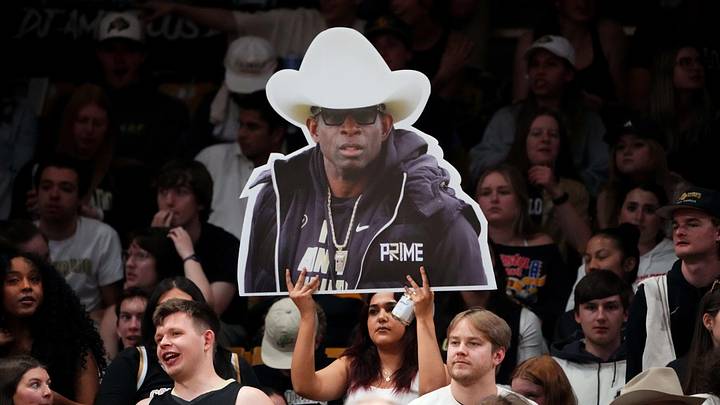 Mar 3, 2024; Boulder, Colorado, USA; Colorado Buffaloes student fan holds a photo cut out of football head coach Deion Sanders during the second half against the Stanford Cardinal at the CU Events Center. Mandatory Credit: Ron Chenoy-Imagn Images