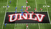 A general overall view as UNLV Rebels quarterback Jayden Maiava (1) takes the snap on the UNLV logo at midfield against the Boise State Broncos in the first half during the Mountain West Championship at Allegiant Stadium. Mandatory Credit: Kirby Lee-Imagn Images