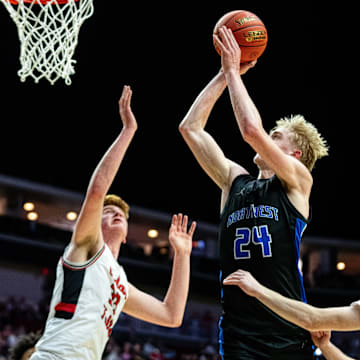 Waukee Northwest's Colin Rice (24) takes a shot over the Cedar Falls defenders on Wednesday, March 12, 2025, at Wells Fargo Arena.