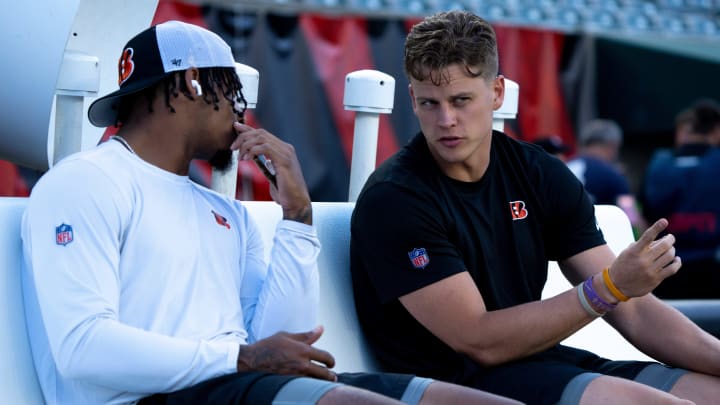 Cincinnati Bengals quarterback Joe Burrow (9) speaks to Cincinnati Bengals wide receiver Ja'Marr Chase (1) before stretching for the NFL game between the Cincinnati Bengals and Los Angeles Rams at Paycor Stadium in Cincinnati on Monday, Sept. 25, 2023.