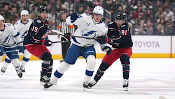 Blue Jackets and Lightning players battle for a loose puck. 