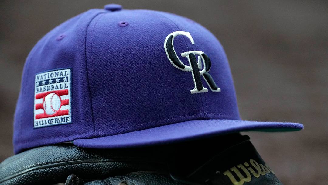 Colorado Rockies hat on top of a glove. Credit: Michael McLoone-Imagn Images