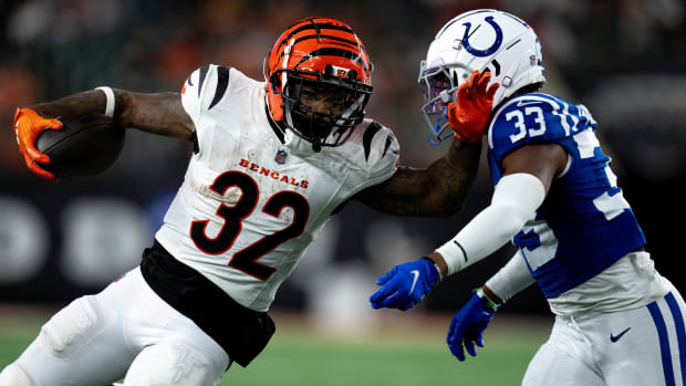 Colts cornerback Micah Abraham (blue jersey; white helmet/pants) attempts to make a tackle on the ball-carrier. 