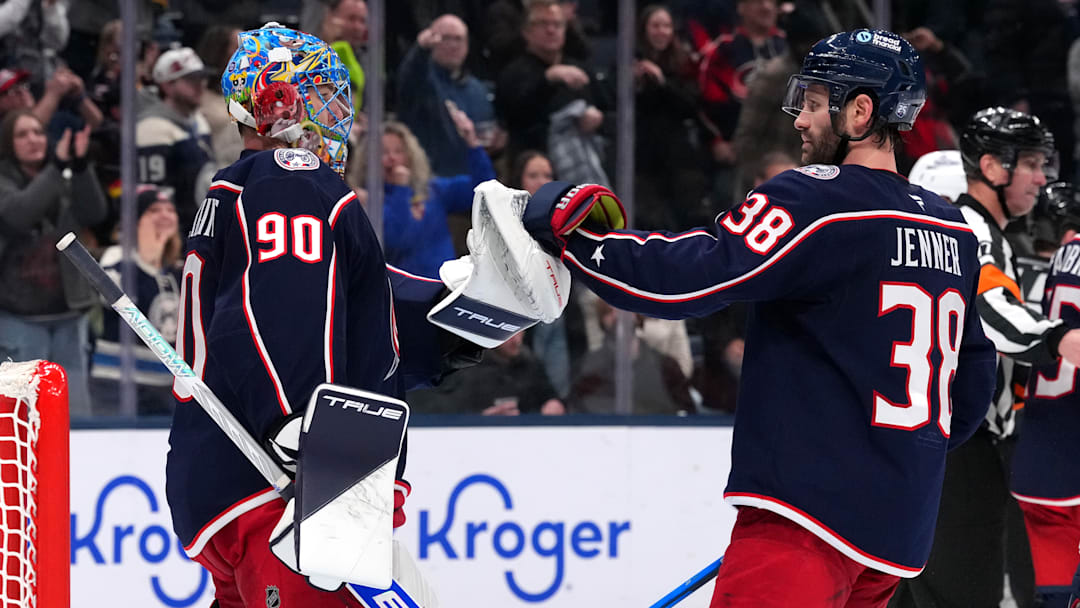 Blue Jackets goaltender Elvis Merzlikins and captain Boone Jenner congratulate each other after a big win over Vancouver.