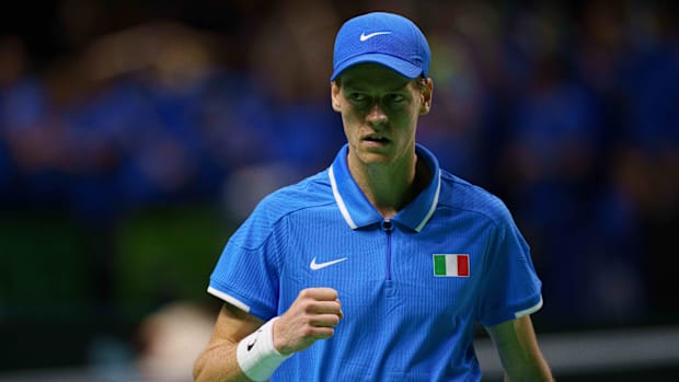 Jannik Sinner pumps his first during a tennis match.