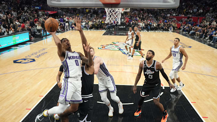Feb 24, 2023; Los Angeles, California, USA; Sacramento Kings guard Malik Monk (0) shoots the ball against the LA Clippersin the second half at Crypto.com Arena. The Kings defeated the Clippers 176-175 in double overtime. Mandatory Credit: Kirby Lee-Imagn Images