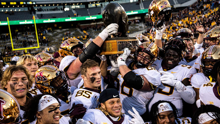 Minnesota players hold the Floyd of Rosedale trophy after defeating Iowa