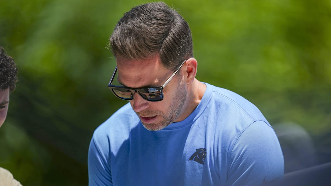 Jun 11, 2025; Charlotte, NC, USA; Carolina Panthers Team Manager Dan Morgan signs an autograph during minicamp at Bank of America Stadium. Mandatory Credit: Jim Dedmon-Imagn Images