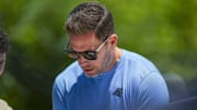 Jun 11, 2025; Charlotte, NC, USA; Carolina Panthers Team Manager Dan Morgan signs an autograph during minicamp at Bank of America Stadium. Mandatory Credit: Jim Dedmon-Imagn Images