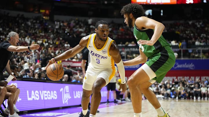 Jul 15, 2024; Las Vegas, NV, USA; Los Angeles Lakers guard Bronny James (9) dribbles the ball against Boston Celtics forward Anton Watson (28) during the first half at Thomas & Mack Center. Mandatory Credit: Lucas Peltier-Imagn Images