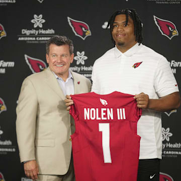 Cardinals defensive lineman Walter Nolen stands and holds his jersey with owner Michael Bidwill (left) during his introductory news conference inside the Arizona Cardinals training facility on April 25, 2025, in Tempe.