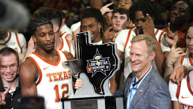 Jan 25, 2025; Austin, Texas, USA; Texas Longhorns guard Tramon Mark (12) holds the Lone Star Showdown trophy after a victory 