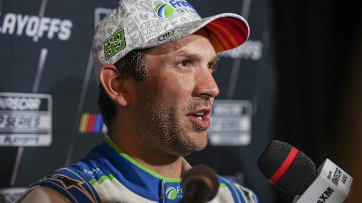 Sep 4, 2024; Charlotte, North Carolina, USA; Daniel Suarez speaks to media members during the NASCAR Playoffs Media Day at the Charlotte Convention Center. Mandatory Credit: Jim Dedmon-Imagn Images