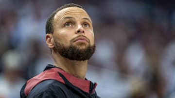 Golden State Warriors guard Stephen Curry looks on from the bench against the Minnesota Timberwolves in the second half.