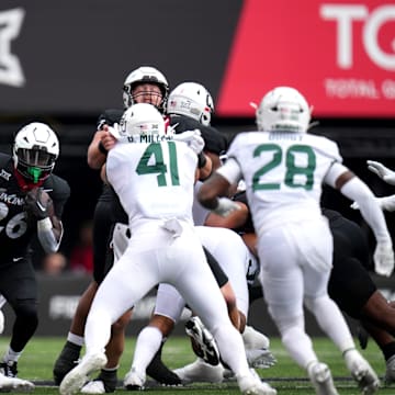 Cincinnati Bearcats running back Myles Montgomery (26) carries the ball as the offensive line blocks in the first quarter during a college football game between the Baylor Bears and the Cincinnati Bearcats, Saturday, Oct. 21, 2023, at Nippert Stadium in Cincinnati.
