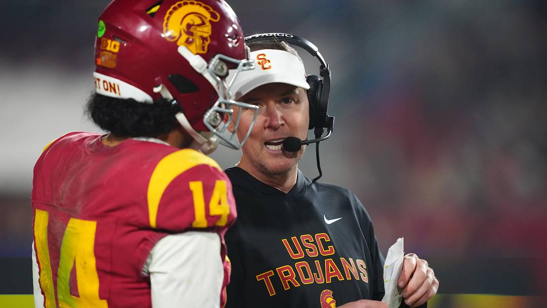 Nov 29, 2025; Los Angeles, California, USA; Southern California Trojans head coach Lincoln Riley (right) talks with quarterback Jayden Maiava (14) in the second half against the UCLA Bruins at United Airlines Field at Los Angeles Memorial Coliseum. Mandatory Credit: Kirby Lee-Imagn Images