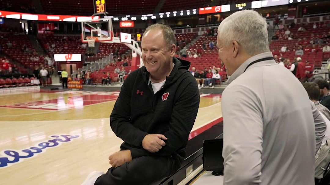Head coach Greg Gard, left, speaks with broadcaster Matt Lepay before a Wisconsin men’s basketball scrimmage Sunday, October 19, 2025 at the Kohl Center in Madison, Wisconsin.