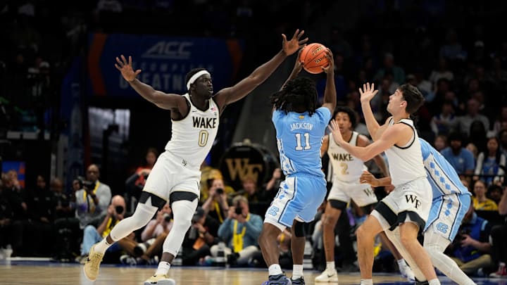 Mar 13, 2025; Charlotte, NC, USA; North Carolina Tar Heels guard Ian Jackson (11) shoots as /Wake Forest Demon Deacons forward Omaha Biliew (0) and guard Parker Friedrichsen (7) defend in the first half at Spectrum Center. Mandatory Credit: Bob Donnan-Imagn Images