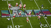 Kansas City Chiefs quarterback Patrick Mahomes runs from Philadelphia Eagles linebacker Haason Reddick during Super Bowl LVII