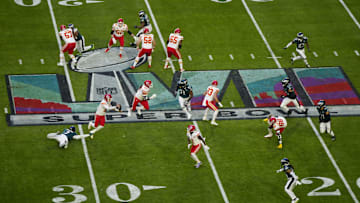 Kansas City Chiefs quarterback Patrick Mahomes runs from Philadelphia Eagles linebacker Haason Reddick during Super Bowl LVII