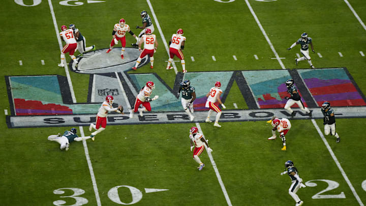 Kansas City Chiefs quarterback Patrick Mahomes runs from Philadelphia Eagles linebacker Haason Reddick during Super Bowl LVII