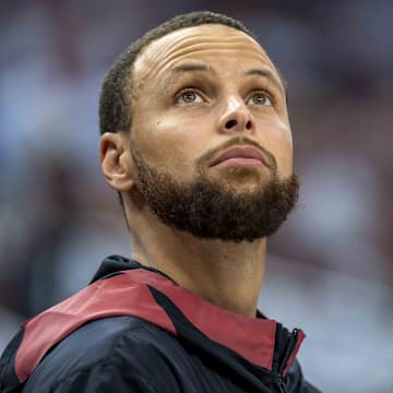 May 8, 2025; Minneapolis, Minnesota, USA; Golden State Warriors guard Stephen Curry (30) looks on from the bench against the Minnesota Timberwolves in the second half during game two of the second round for the 2025 NBA Playoffs at Target Center.
