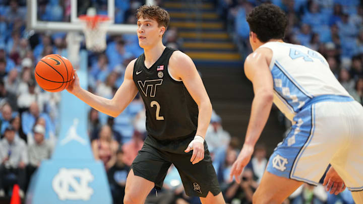 Feb 28, 2026; Chapel Hill, North Carolina, USA; Virginia Tech Hokies guard Jaden Schutt (2) passes the ball as North Carolina Tar Heels guard Luka Bogavac (44) defends in the first half at Dean E. Smith Center. 