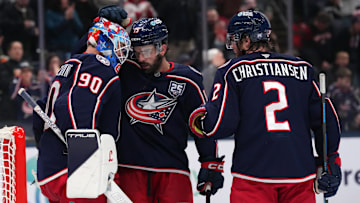 Blue Jackets defensemen Dante Fabbro and Jake Christiansen celebrate last night's win over the Leafs with Elvis Merzlikins.