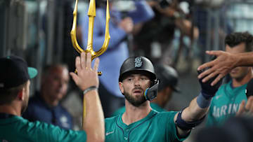 Aug 21, 2024; Los Angeles, California, USA; Seattle Mariners right fielder Mitch Haniger (17) holds a pitchfork after hitting a home run in the ninth inning against the Los Angeles Dodgers at Dodger Stadium. Mandatory Credit: Kirby Lee-Imagn Images