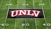 The UNLV Rebels logo at midfield during the Mountain West Championship at Allegiant Stadium. Mandatory Credit: Kirby Lee-Imagn Images