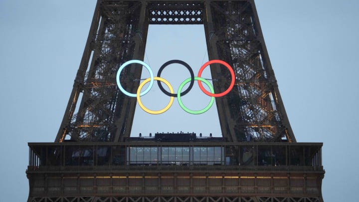 Jul 26, 2024; Paris, FRANCE; The Olympic rings on the Eiffel Tower light up during the Opening Ceremony for the Paris 2024 Olympic Summer Games along the Seine River.