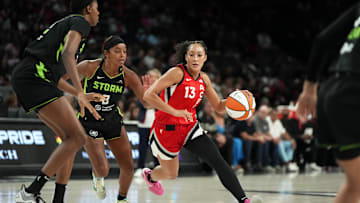 Jun 20, 2025; Las Vegas, Nevada, USA; Las Vegas Aces guard Aaliyah Nye (13) drives the ball against Seattle Storm guard Lexie Brown (8) during the first half of a WNBA basketball game at Michelob Ultra Arena. 