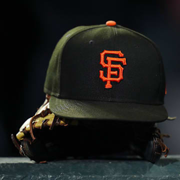 General view of a San Francisco Giants cap and glove during the ninth inning against the Colorado Rockies at Coors Field. 