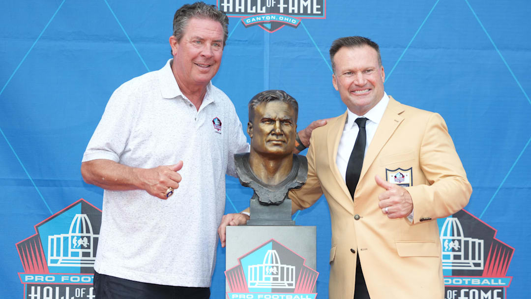 Miami Dolphins former linebacker Zach Thomas (right) poses with his bust and former quarterback Dan Marino during the 2023 Pro Football Hall of Fame Enshrinement at Tom Benson Hall of Fame Stadium.