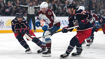 Blue Jackets defensemen Ivan Provorov and Damon Severson compete for the puck against Colorado.