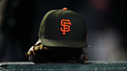 Sep 15, 2023; Denver, Colorado, USA; General view of a San Francisco Giants cap and glove during the ninth inning against the Colorado Rockies at Coors Field. 
