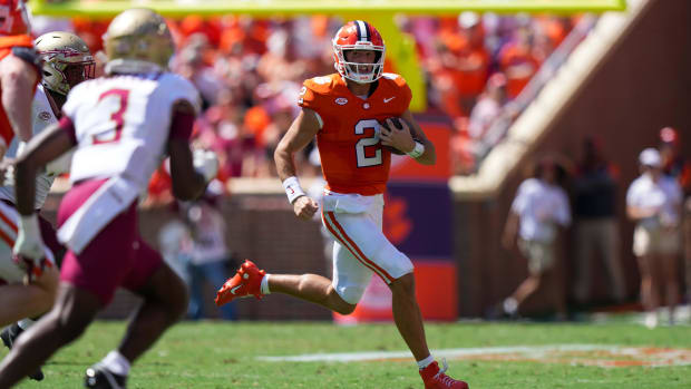 Clemson Tigers quarterback Cade Klubnik runs against the Florida State Seminoles in a college football game in the ACC.