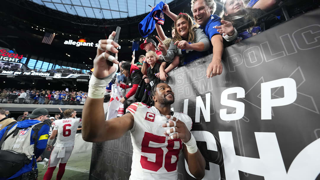 Dec 28, 2025; Paradise, Nevada, USA; New York Giants inside linebacker Bobby Okereke (58) takes a photo with fans after the game against the Las Vegas Raiders at Allegiant Stadium. Mandatory Credit: Kirby Lee-Imagn Images