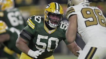 Dec 23, 2024; Green Bay, Wisconsin, USA;  Green Bay Packers guard Zach Tom (50) blocks New Orleans Saints defensive end Payton Turner (98) during the third quarter at Lambeau Field. Mandatory Credit: Mark Hoffman/Milwaukee Journal Sentinel/Imagn Images