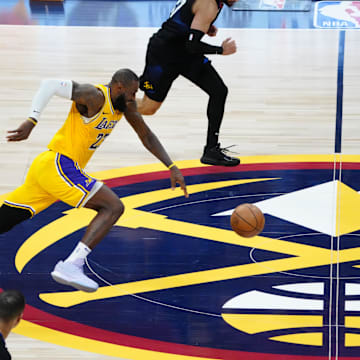 Apr 22, 2024; Denver, Colorado, USA; Los Angeles Lakers forward LeBron James (23) and Denver Nuggets guard Jamal Murray (27) in the fourth quarter during game two during the 2024 NBA playoffs at Ball Arena. Mandatory Credit: Ron Chenoy-Imagn Images