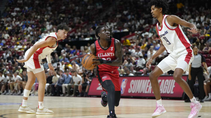 Jul 12, 2024; Las Vegas, NV, USA;  Atlanta Hawks guard Keaton Wallace (22) drives the ball against Washington Wizards forward John Butler Jr. (19) during the first half at Thomas & Mack Center. Mandatory Credit: Lucas Peltier-USA TODAY Sports