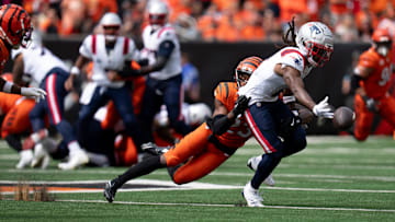 Cincinnati Bengals cornerback Dax Hill (23) hits New England Patriots wide receiver K.J. Osborn (2) as he drops a pass in the first quarter of the NFL game at Paycor Stadium in Cincinnati on Sunday, Sept. 8, 2024.