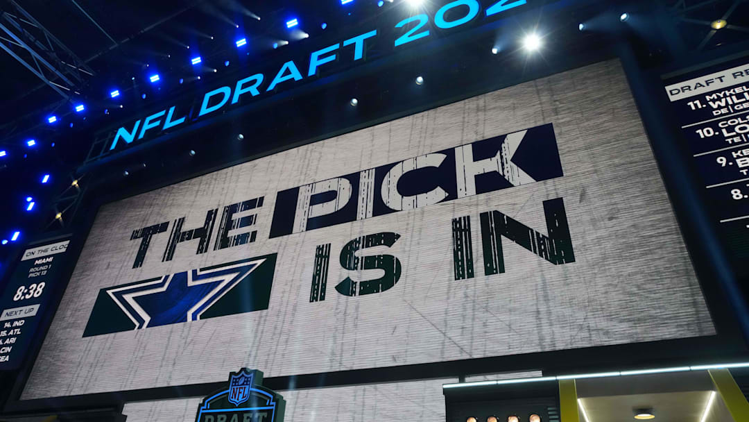 The Dallas Cowboys logo is projected on the video board during the NFL Draft at Lambeau Field. 